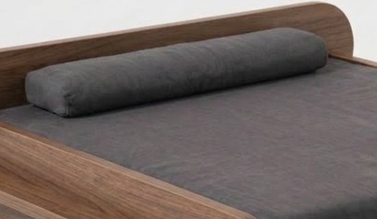 Grey bolster pillow on the bed